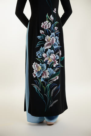 Close-up of intricate floral hand-painted design on black silk Ao Dai.