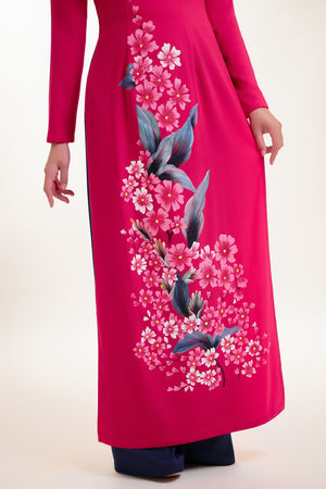 Close-up of hand-painted floral details on fuchsia pink Ao Dai silk.