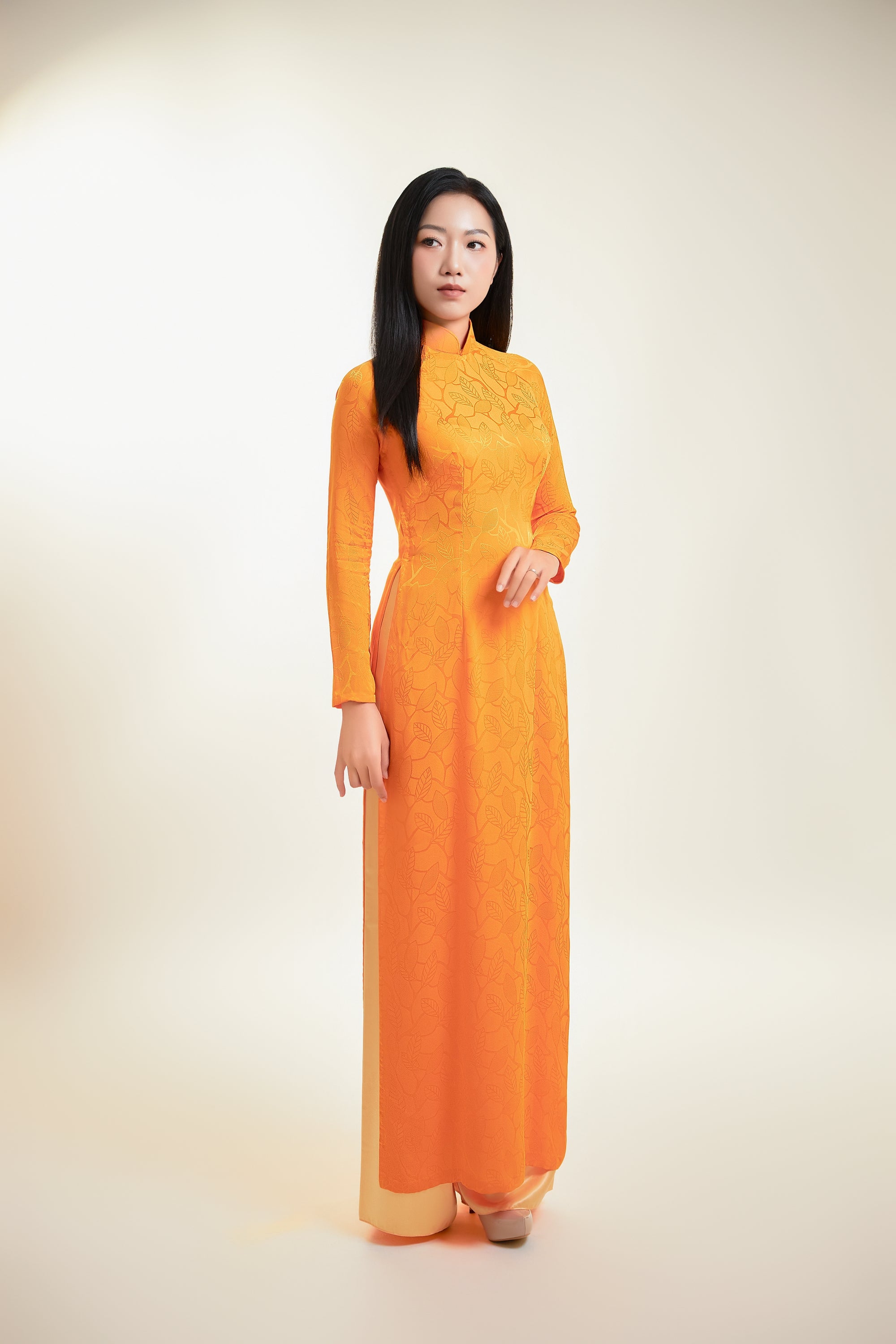 Thai Tuan Silk Brocade Ao Dai in Orange with Leaf Pattern