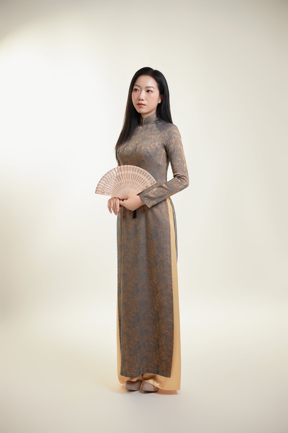 Thai Tuan Silk Brocade Ao Dai with Black and Gold Floral Pattern