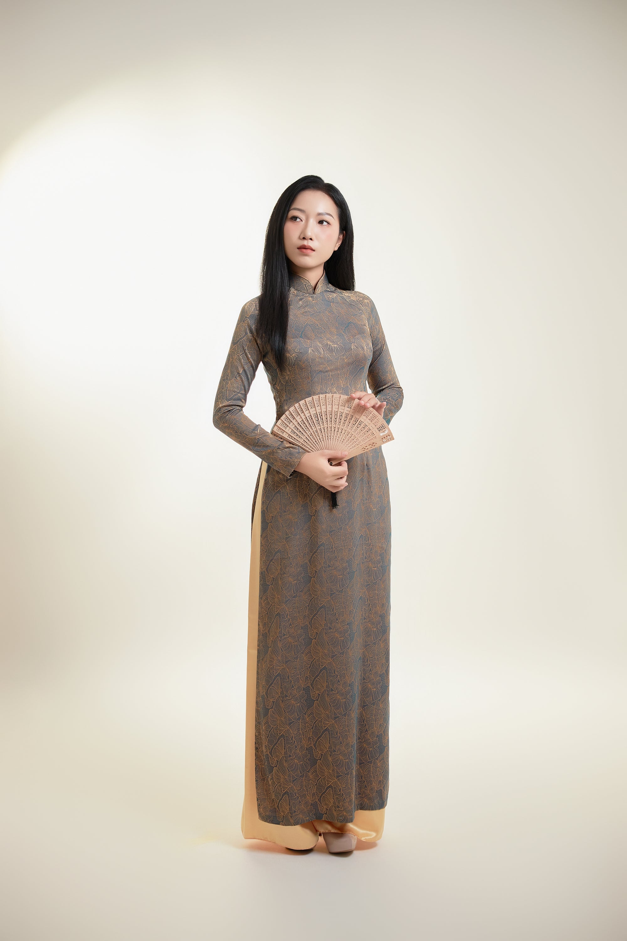 Thai Tuan Silk Brocade Ao Dai with Black and Gold Floral Pattern