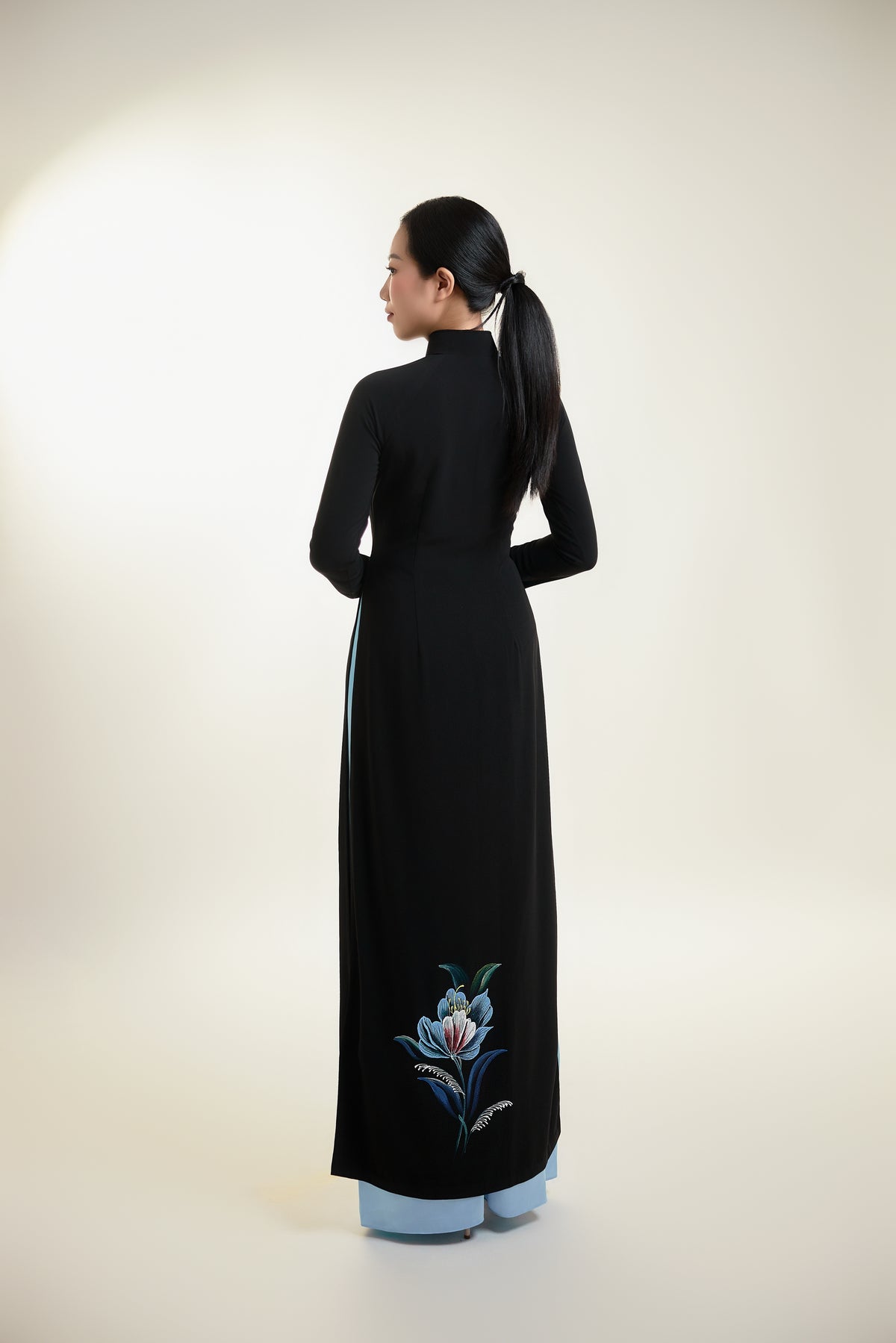 Back view of black silk Ao Dai with subtle floral hand-painted detail.