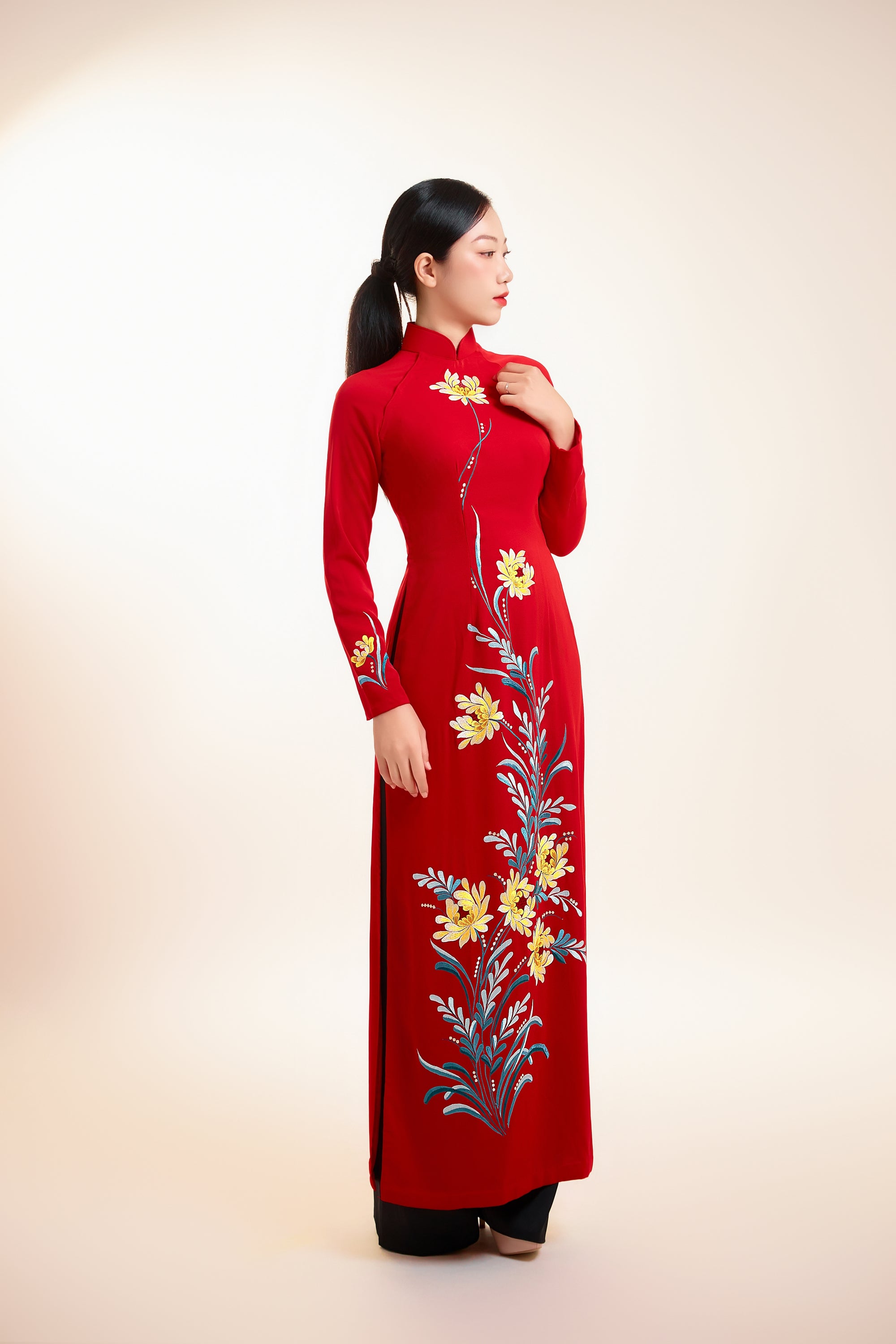 Red silk Ao Dai with chrysanthemum embroidery on the front, featuring long sleeves and a fitted design.