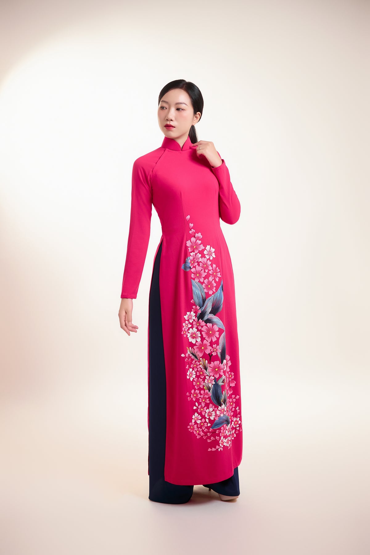 Elegant hand-painted Ao Dai on fuchsia pink silk with floral design.