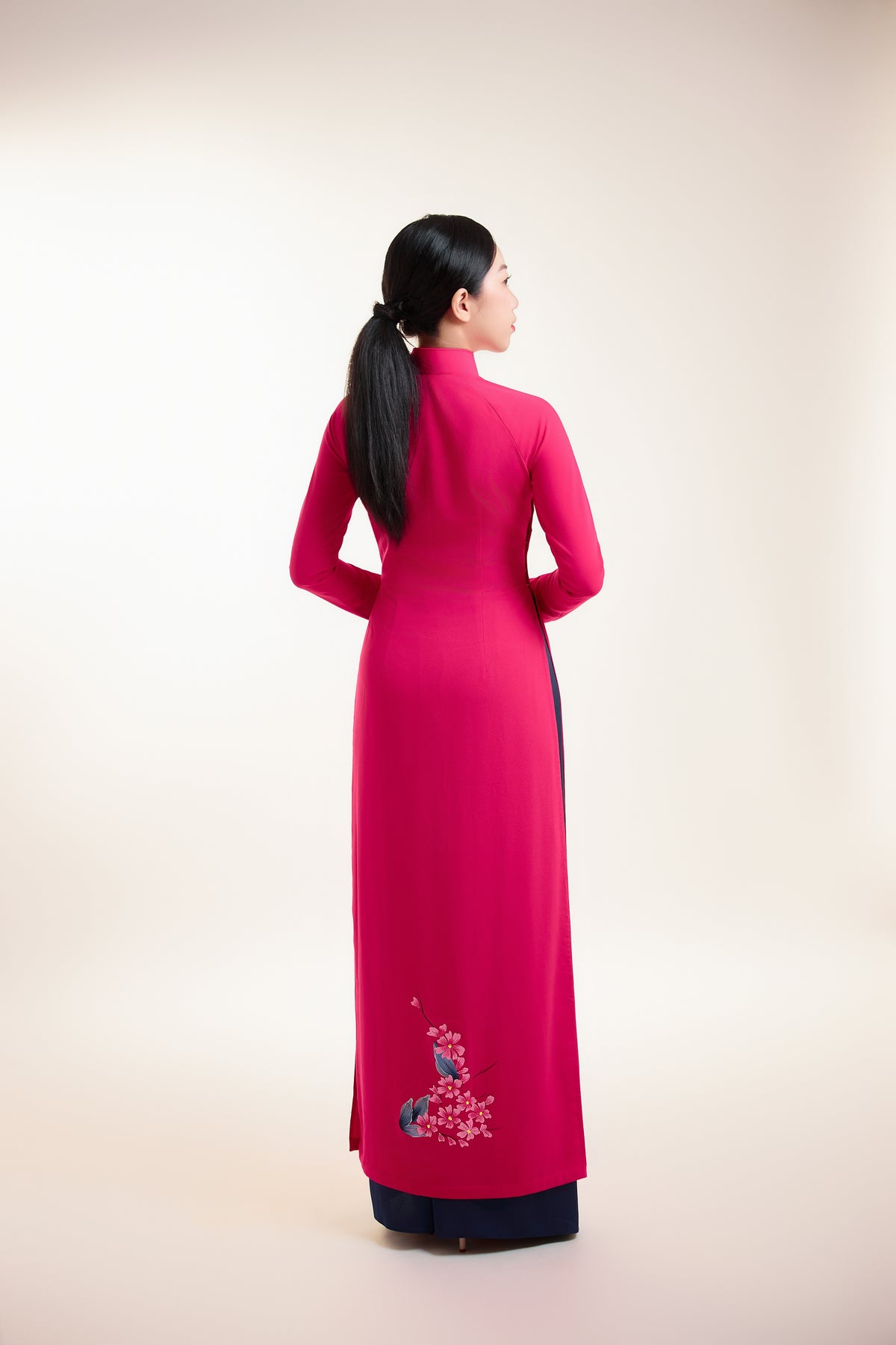 Back view of fuchsia pink silk Ao Dai with subtle hand-painted accents.