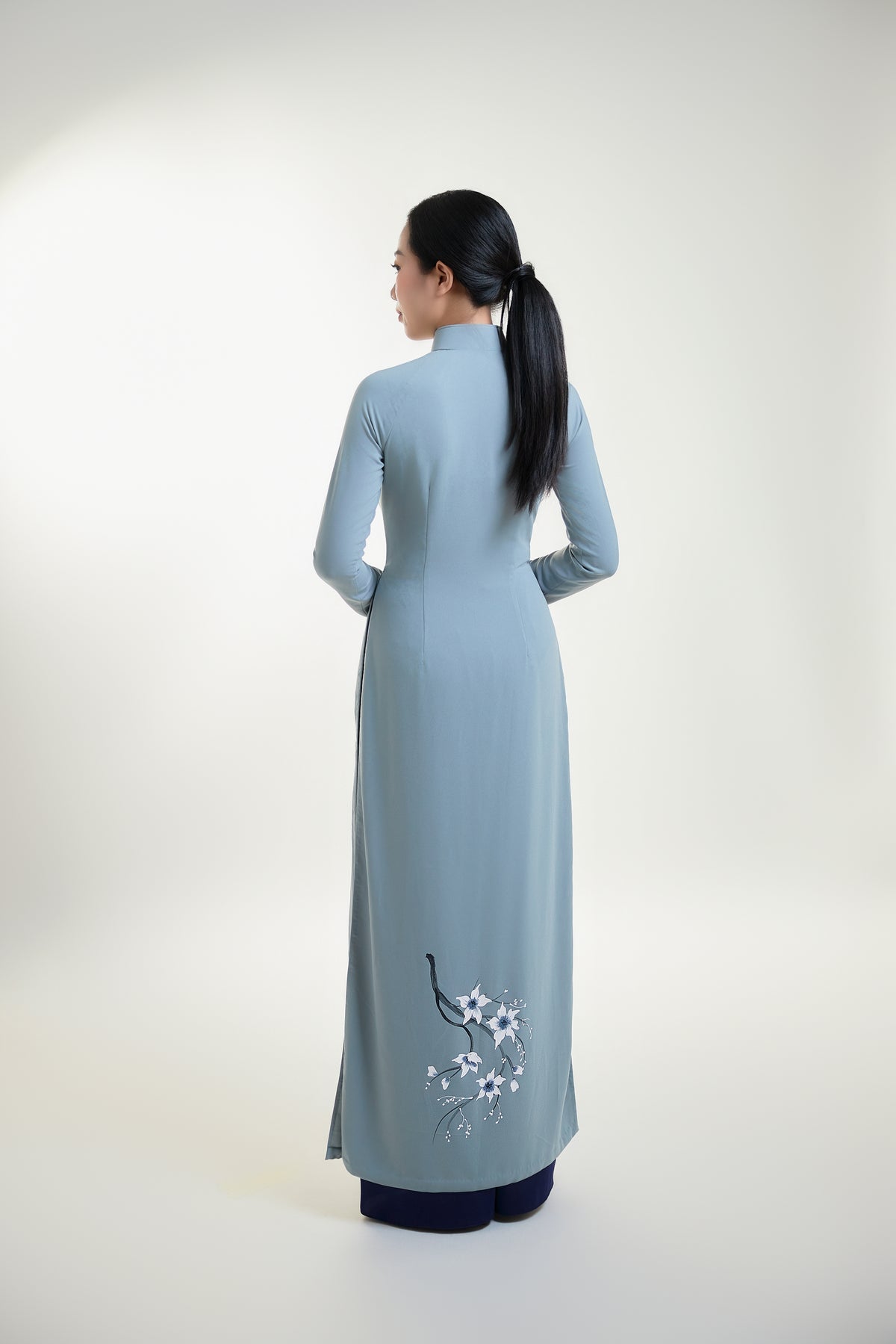 Back view of grey silk Ao Dai with subtle floral hand-painted design.