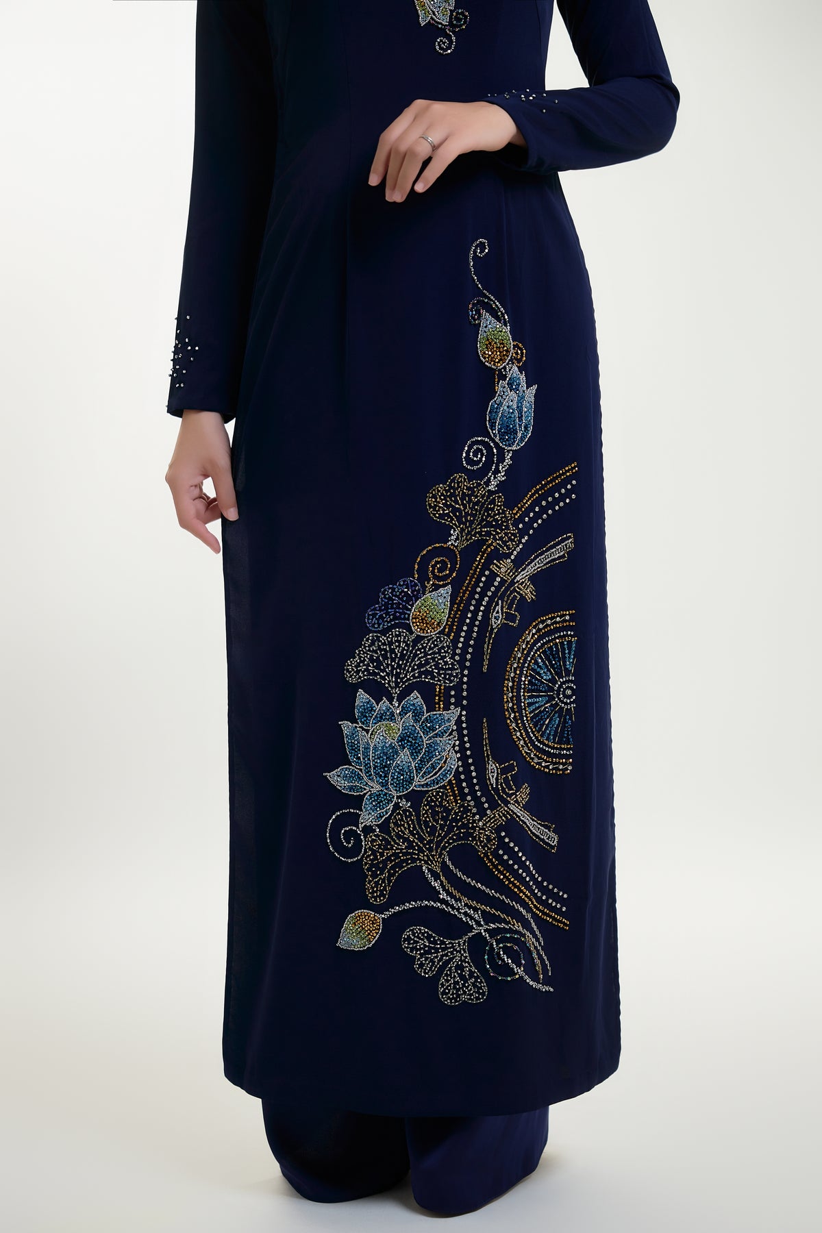Hand-beaded Ao Dai featuring intricate lotus and Trong Dong designs, showcasing traditional Vietnamese craftsmanship.
