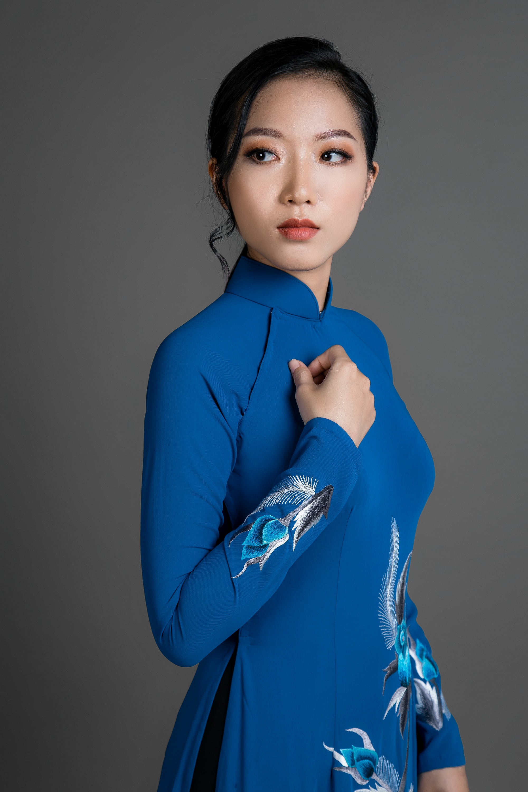 Ao dai Vietnam traditional dress. Blue silk long dress with stunning embroidered rose motif.