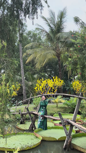 Custom made ao dai. Unique, lotus hand-painted in elegant, dark green color.