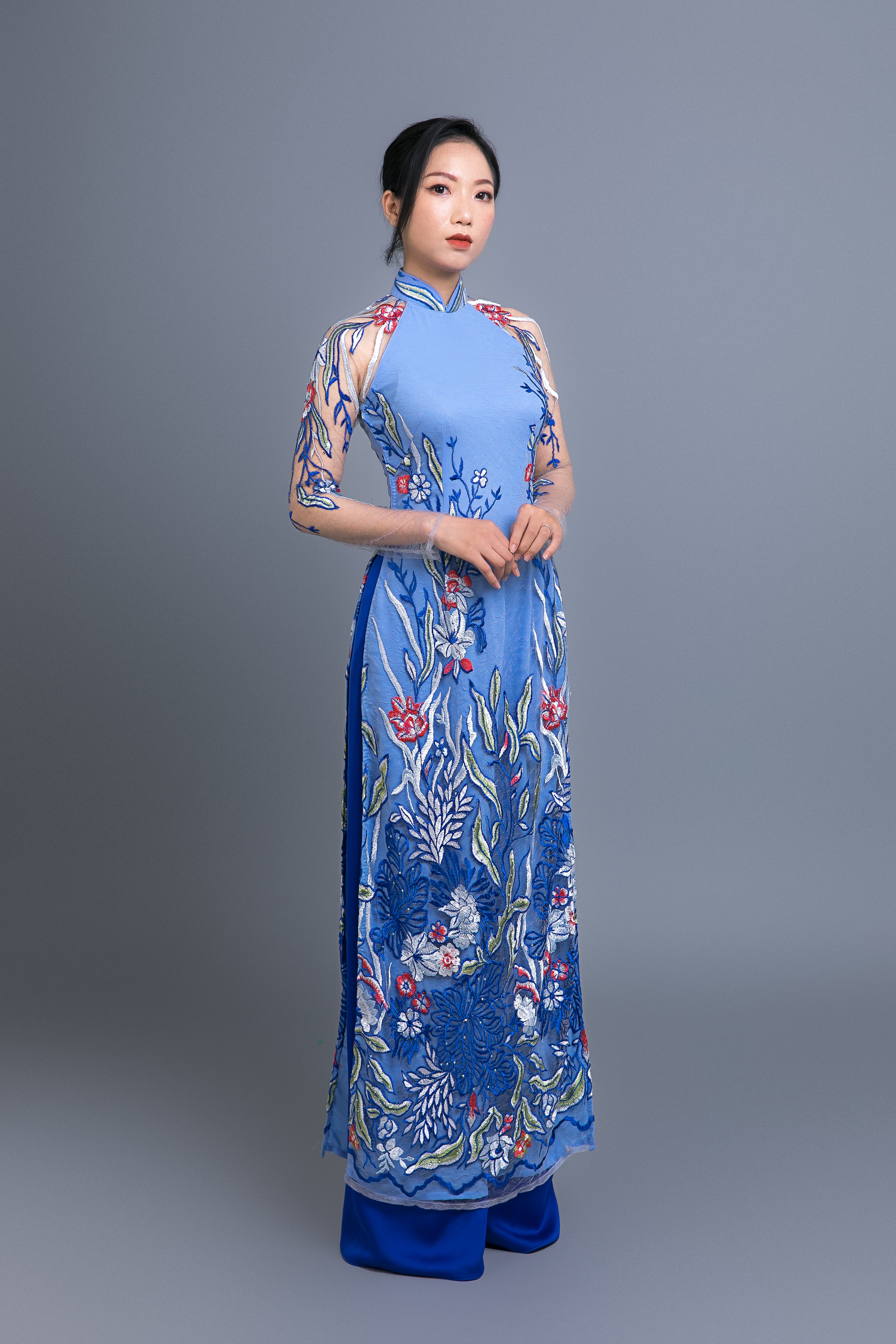 Custom Ao Dai. Multicolored, floral motif lace over light blue