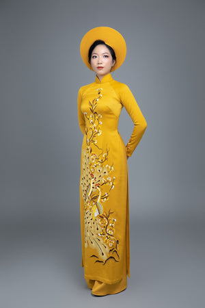 Custom made Vietnamese ao dai dress in yellow with embroidered, peacock motif