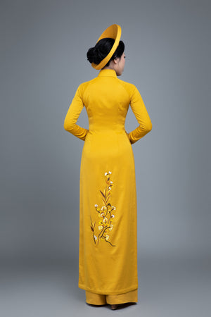 Custom made Vietnamese ao dai dress in yellow with embroidered, peacock motif
