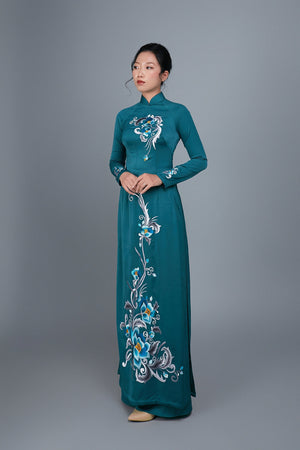 Women's ao dai dress Vietnamese traditional long dress. High quality teal colored fabric with embroidered, floral motif.