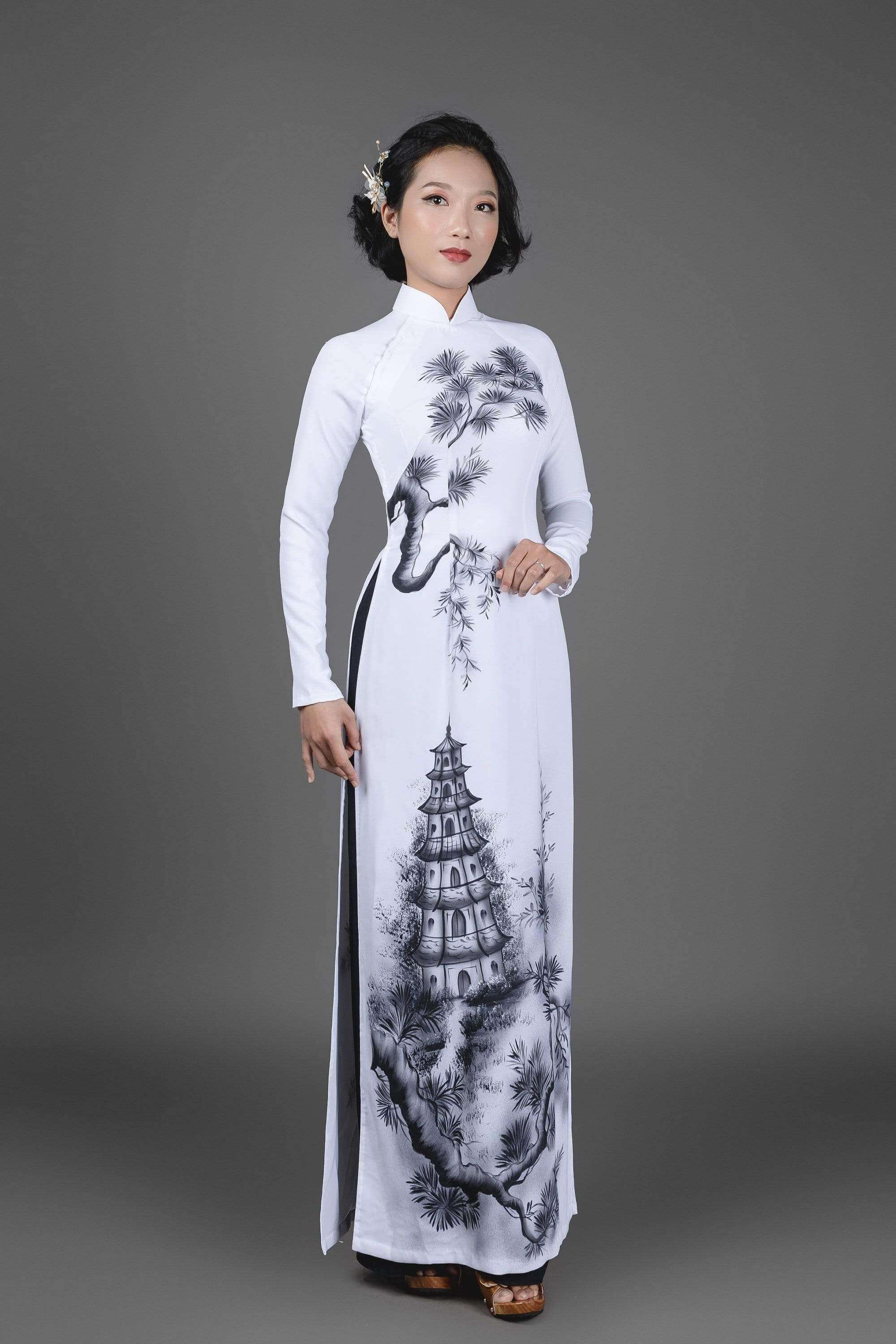 Vietnamese Ao Dai dress in white silk fabric. Hand-painted, pagoda